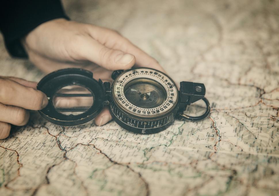 Download Free Stock Photo of Person Holding Compass Over Map - The Path Forward 