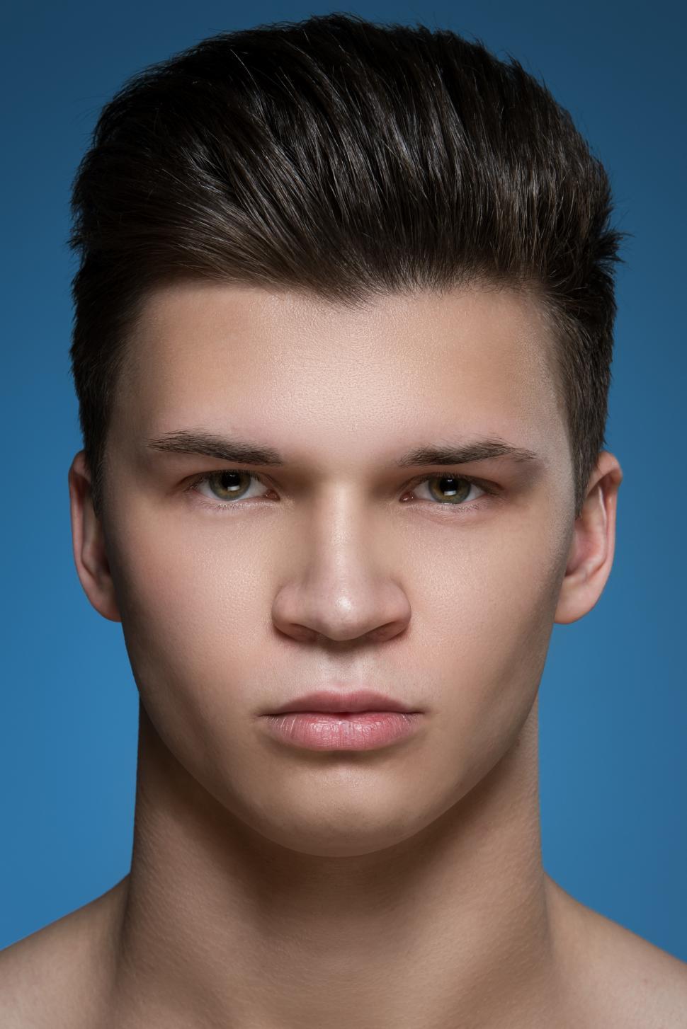 Free Image of Young man on blue background - headshot 