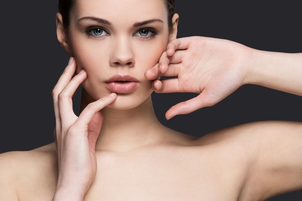 Free Image of Attractive model facing the camera, hands at face 