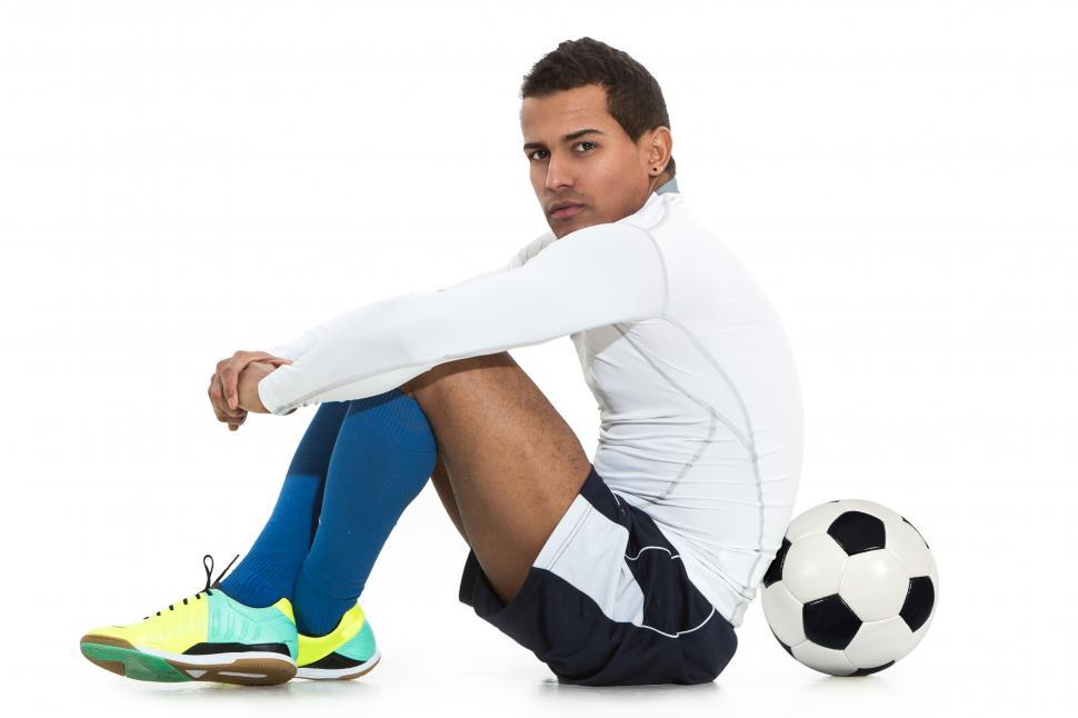 Download Free Stock Photo of Football player sitting with ball 