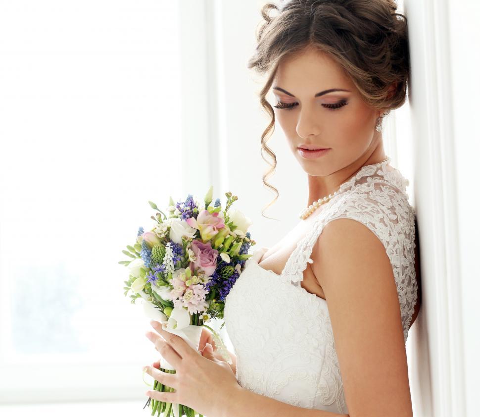 Free Image of Wedding. Beautiful bride portrait against white wall 