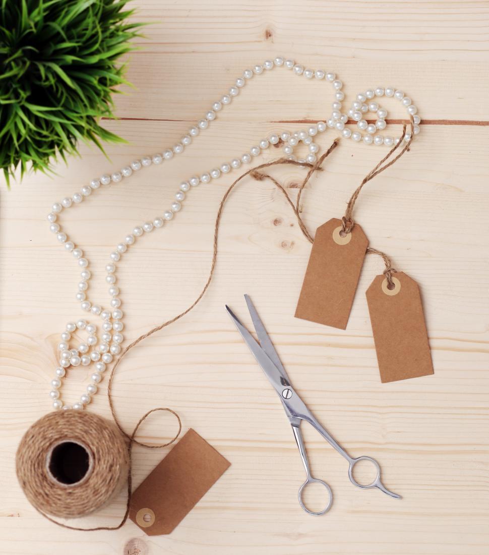 Free Image of Objects on the table - twine, scissors and tags 