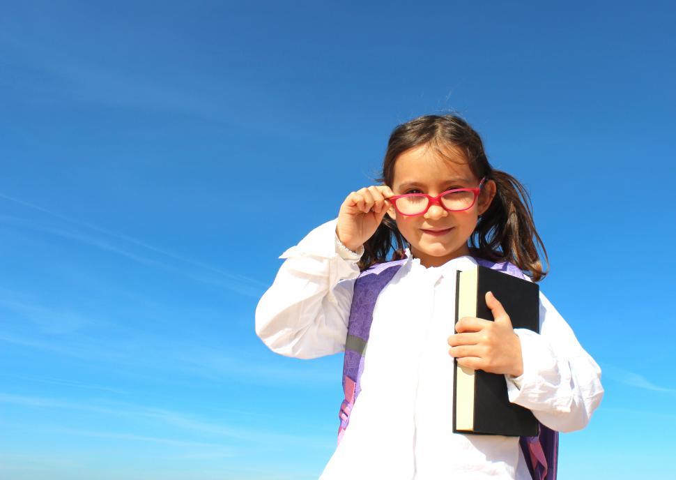 Free Image of Portrait of Little Girl with Book Straightening Glasses - Educat 