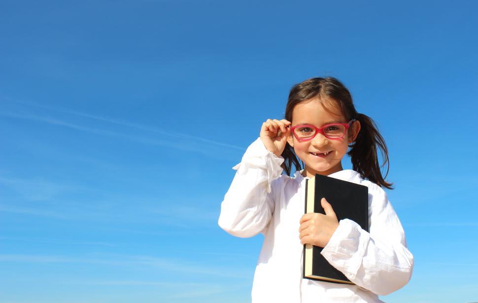Free Image of Sweet Little Girl Holding a Book - Education Concept 