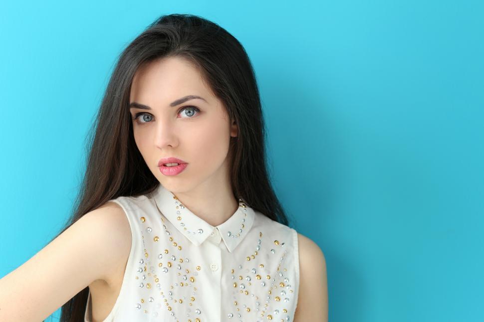 Free Image of Young woman on a bright blue background 