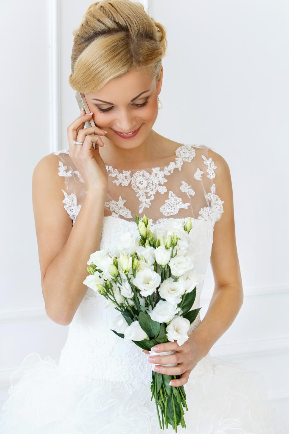 Free Image of Wedding. Beautiful bride talking on the phone 
