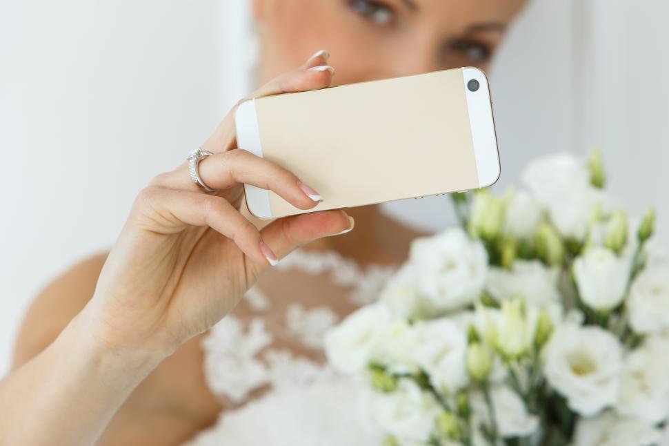 Free Image of Wedding. Bride holding a smartphone 