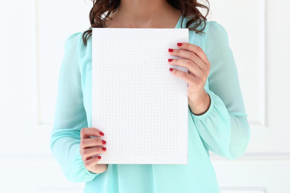 Free Image of Anonymous woman holding blank notebook paper 