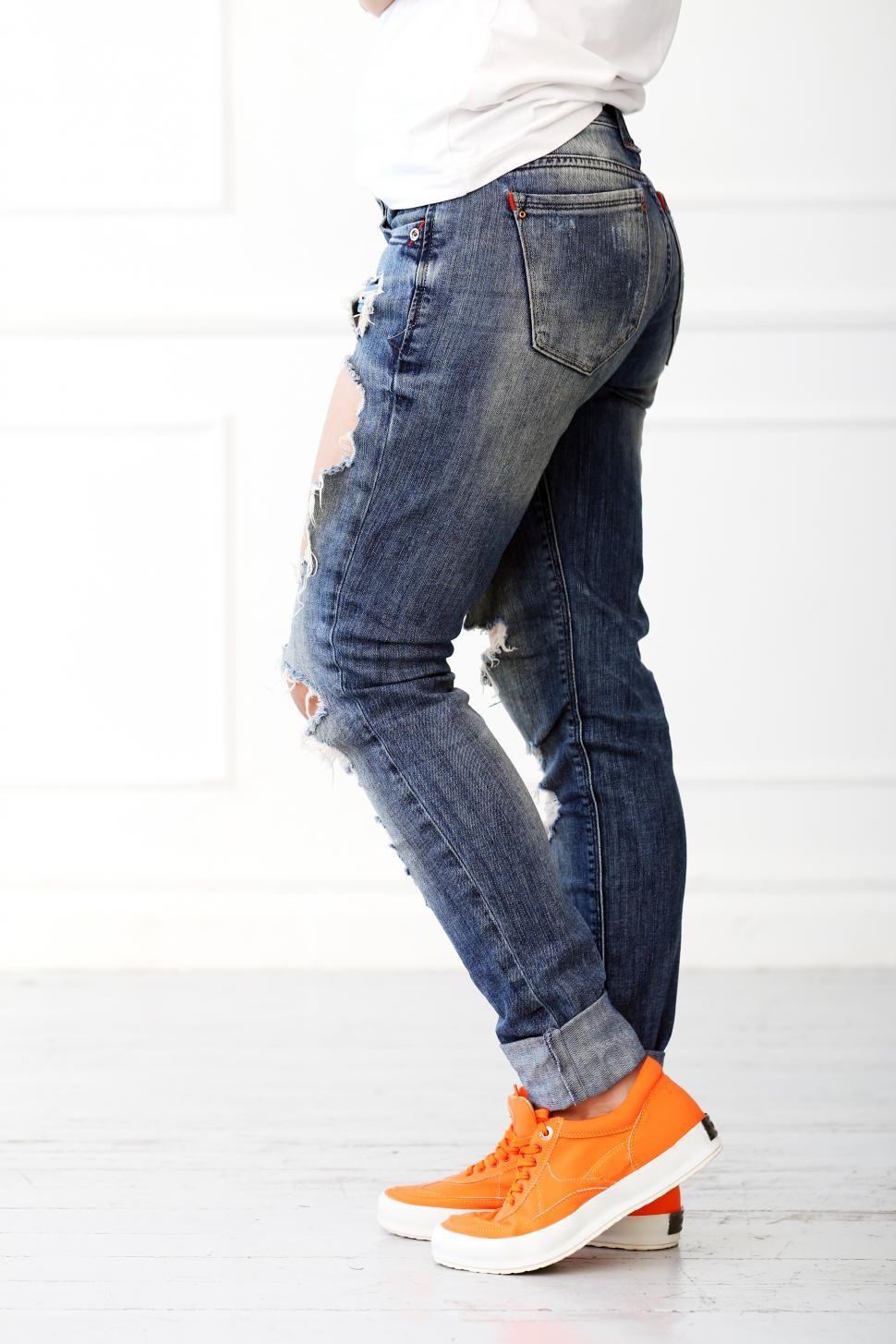 Free Image of Girl with orange shoes and ripped jeans 