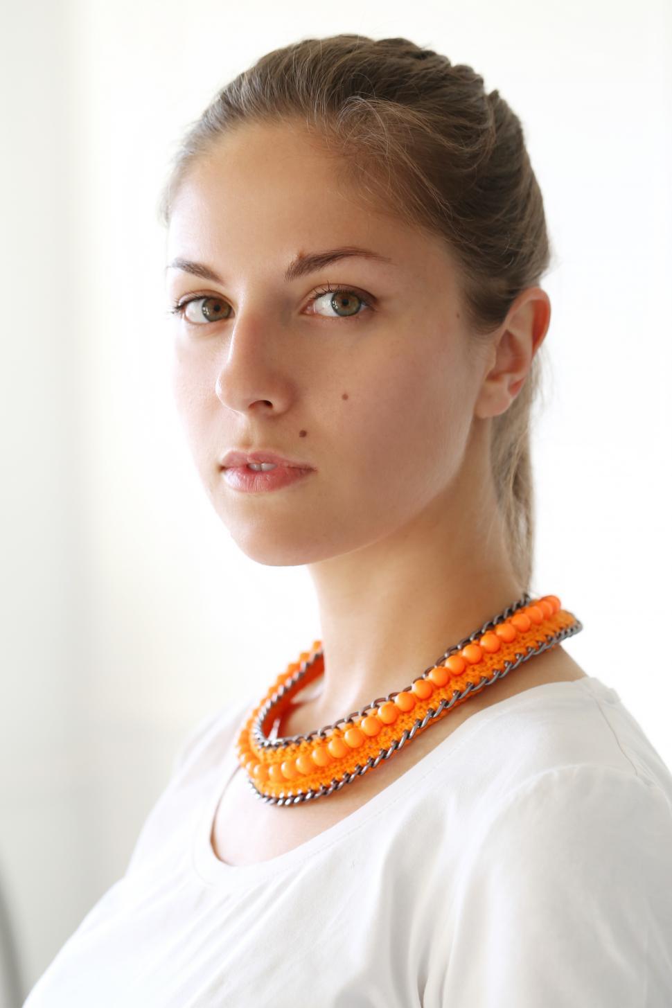 Free Image of Girl with wearing orange necklace 