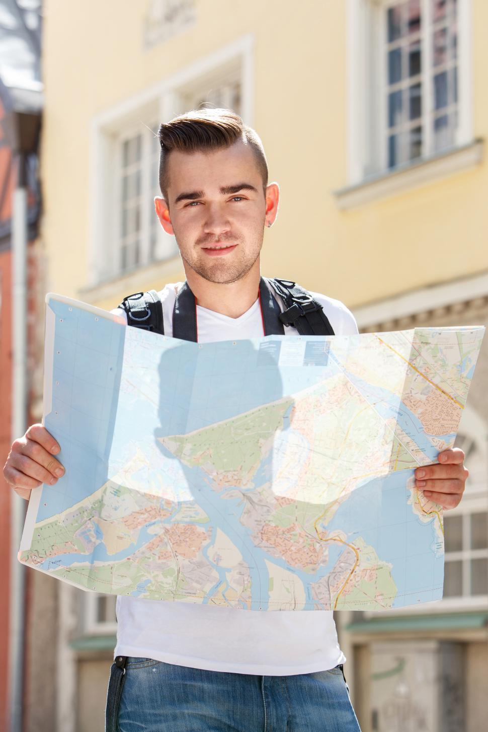 Free Image of Man in the city, finding his way with a map 