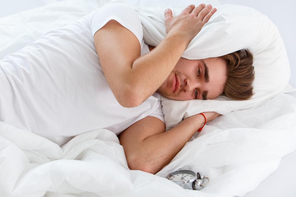 Free Image of Young man trying to get some sleep 
