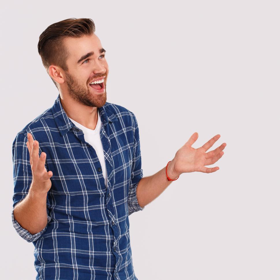 Free Image of Emotions. Young man laughing with open hands 