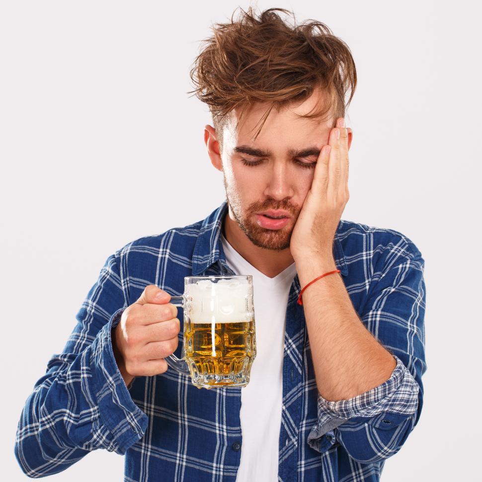 Free Image of Alcohol. Guy in blue shirt with beer. Too many beers. 