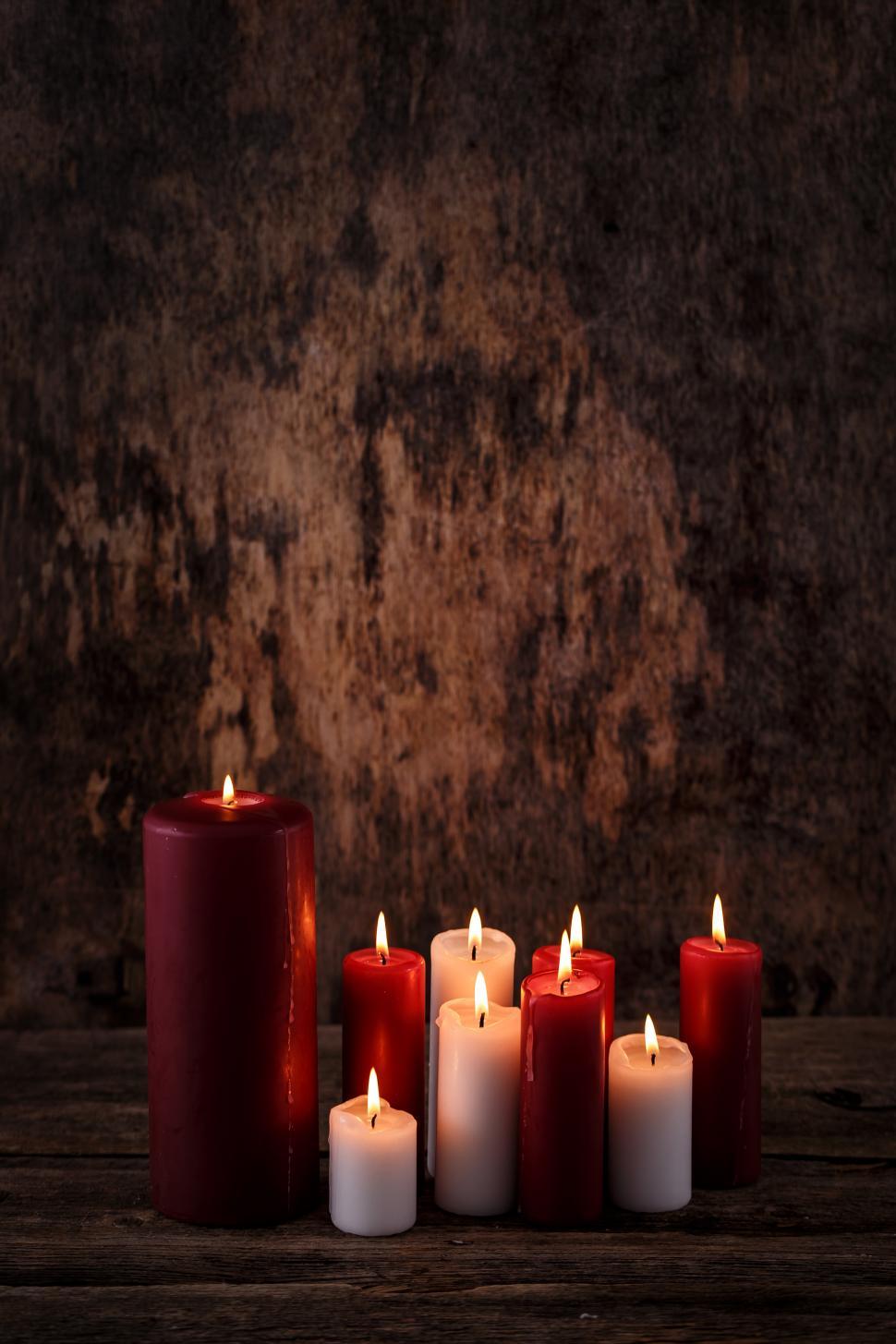 Free Image of Group of lit candles on a table 