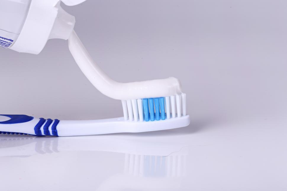 Free Image of Toothpaste being applied to a toothbrush 