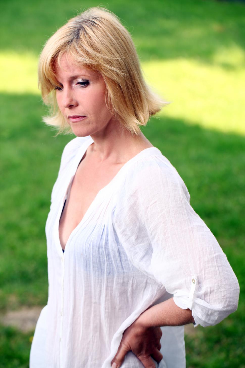 Free Image of Mature woman on the grass in the park 