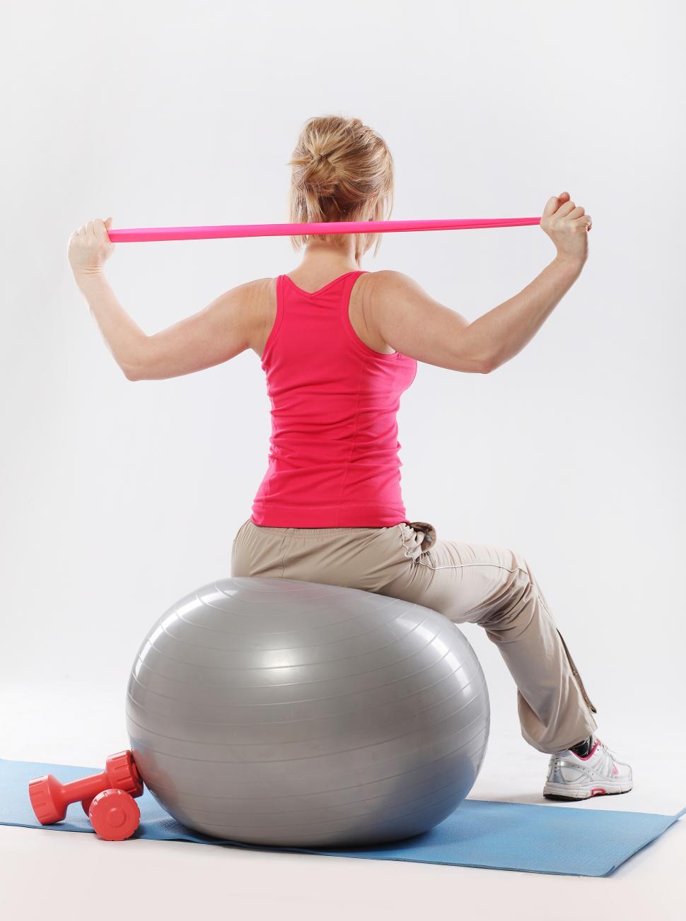 Free Image of Woman working out on an exercise ball 