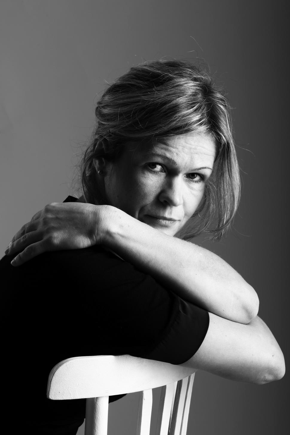 Free Image of Black and white photo of woman with arms crossed 