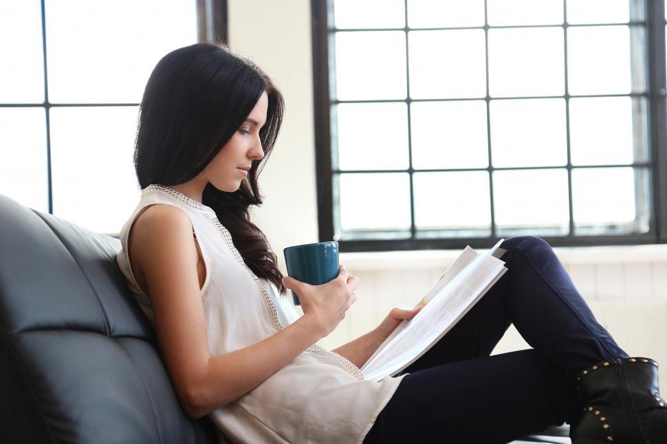Free Image of Woman on the couch, reading 