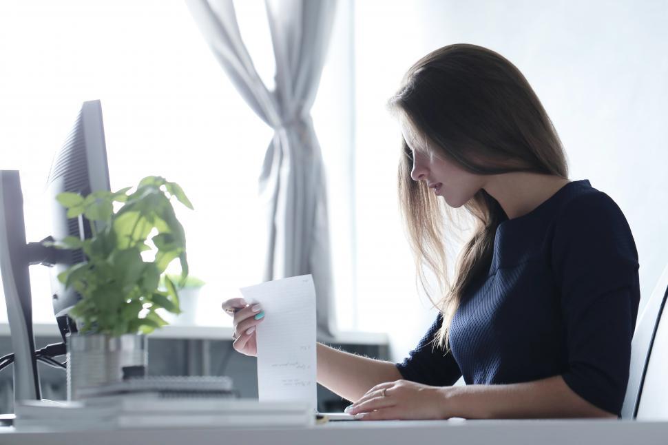 Free Image of Woman working at a desk in a bright room 
