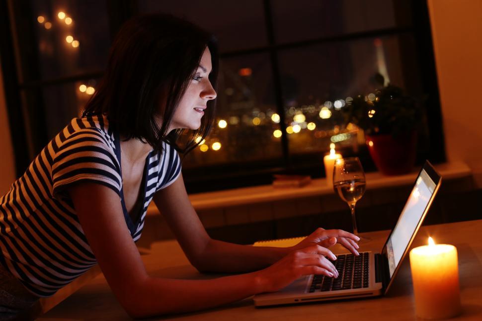 Free Image of Woman browsing on laptop in romantic scene 