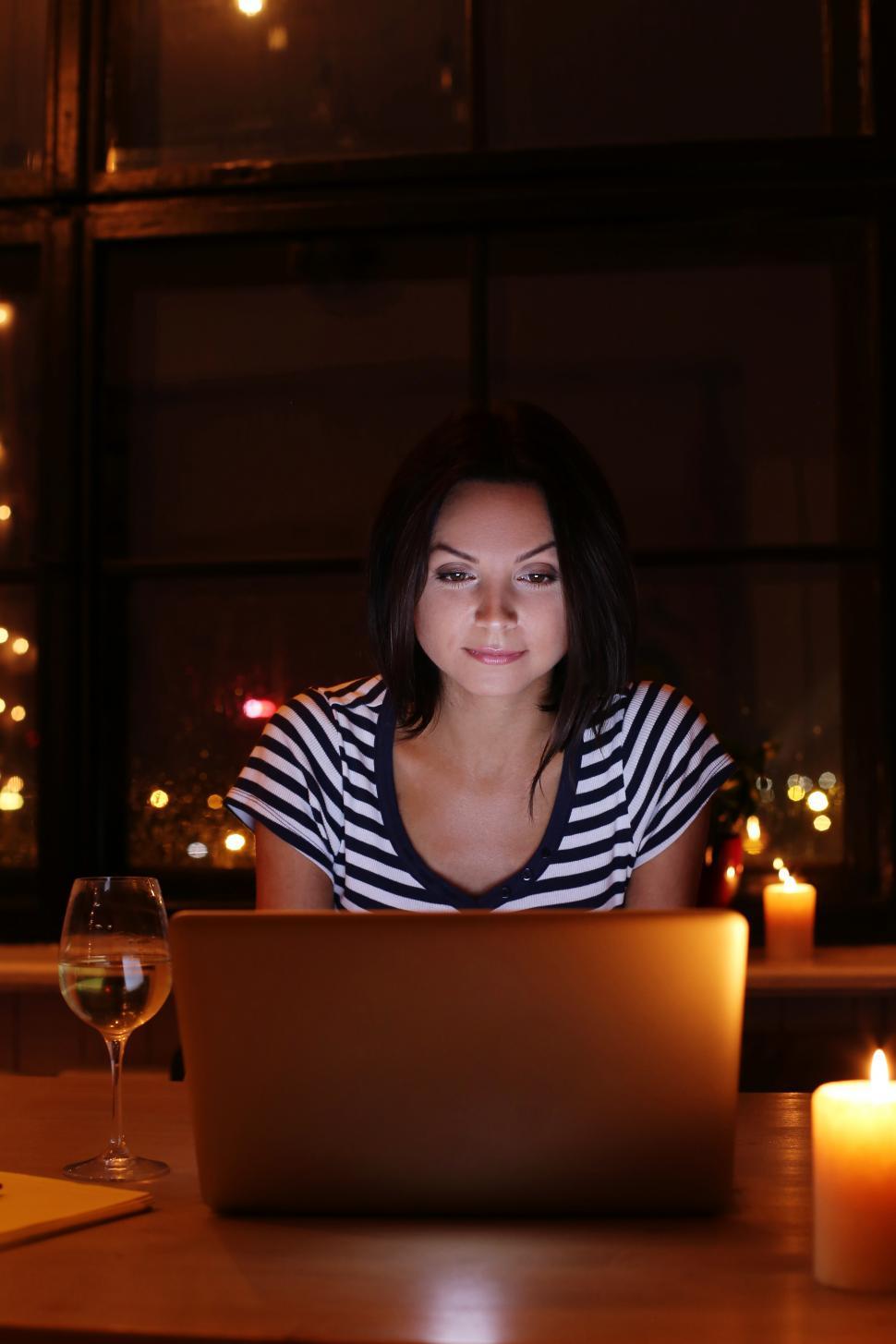 Free Image of Woman in warm scene at home with laptop computer 