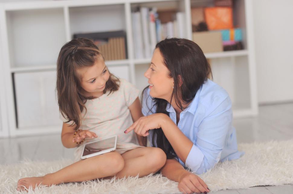 Free Image of Mother with daughter, chatting while on the floor 