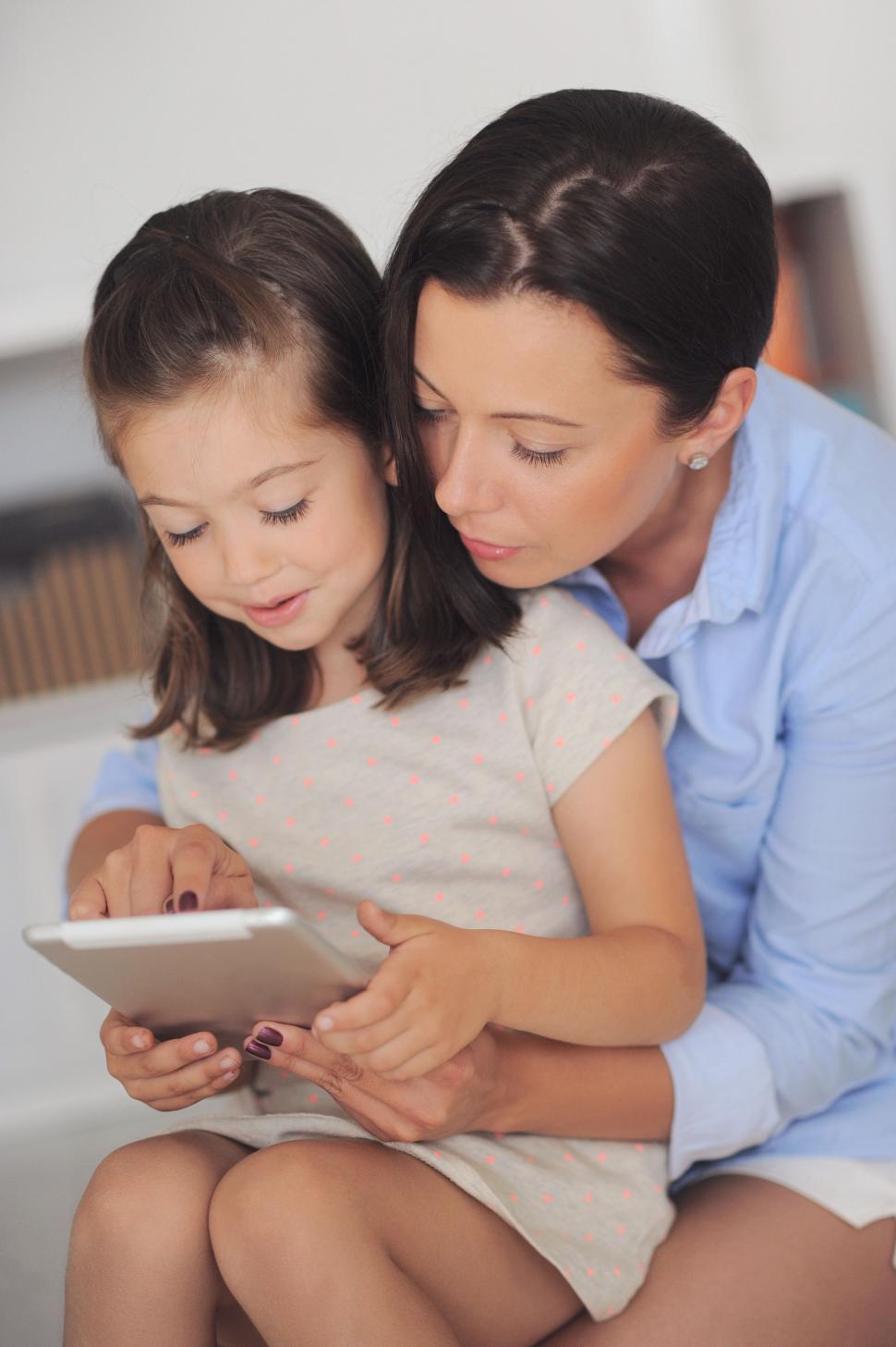 Free Image of Mother and daughter working together on a tablet computer 