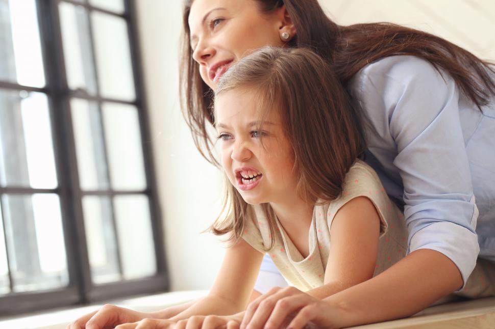 Free Image of Snarling little girl with mother 