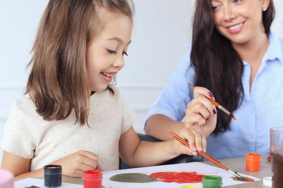 Free Image of Mother and daughter painting together 