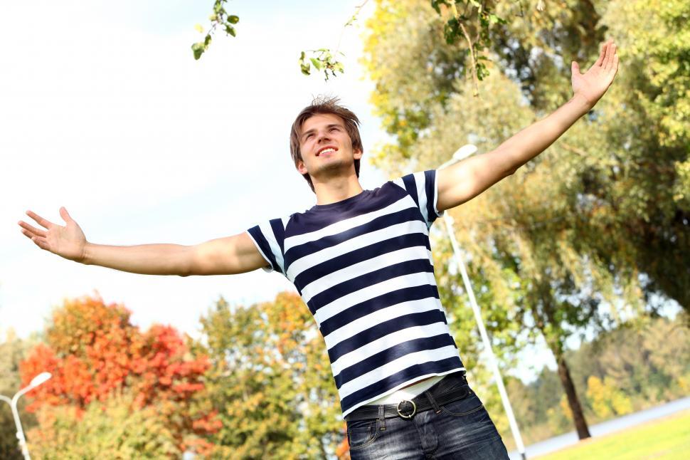 Free Image of Man with arms spread wide, outdoors 