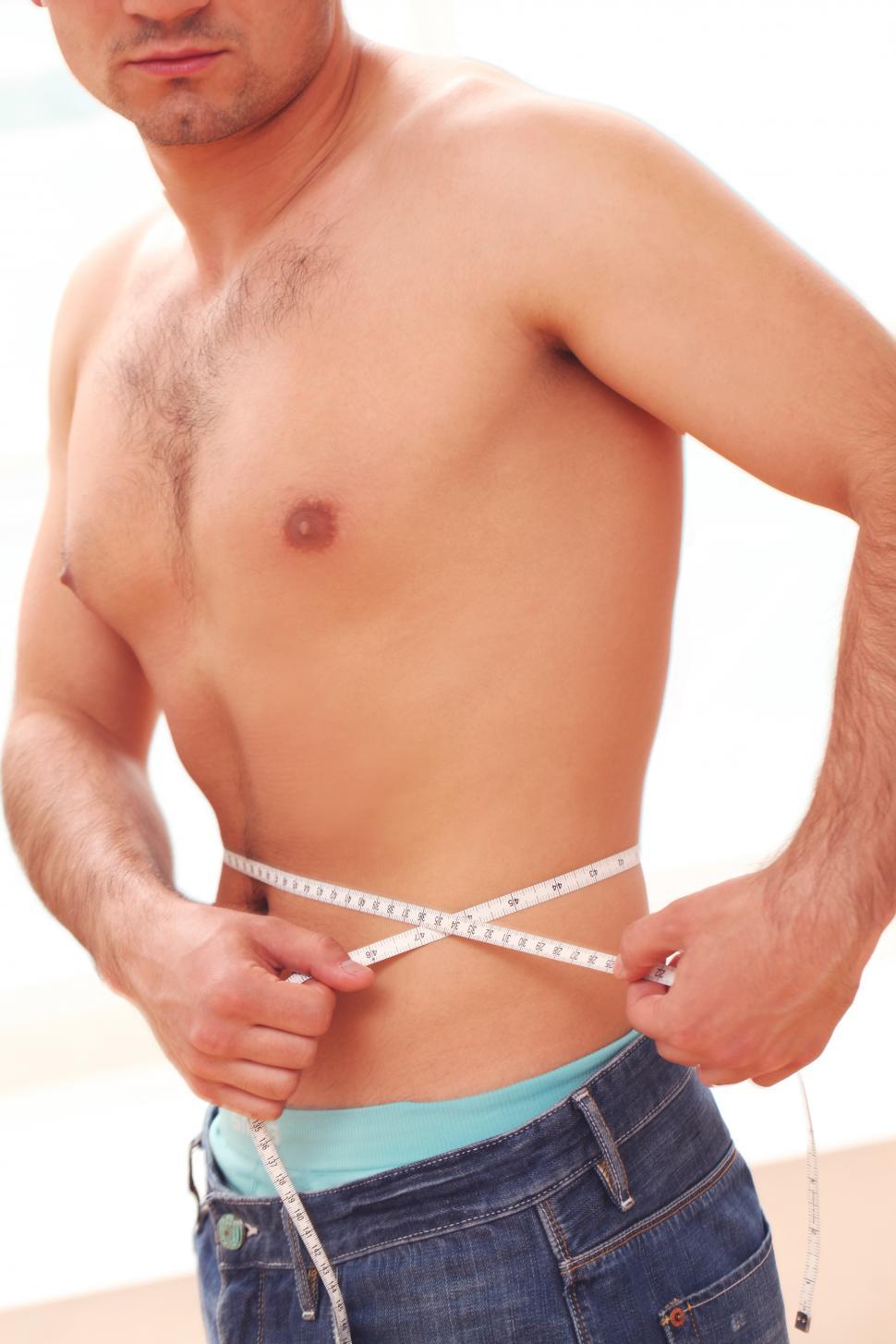 Free Image of Guy measuring his waist 
