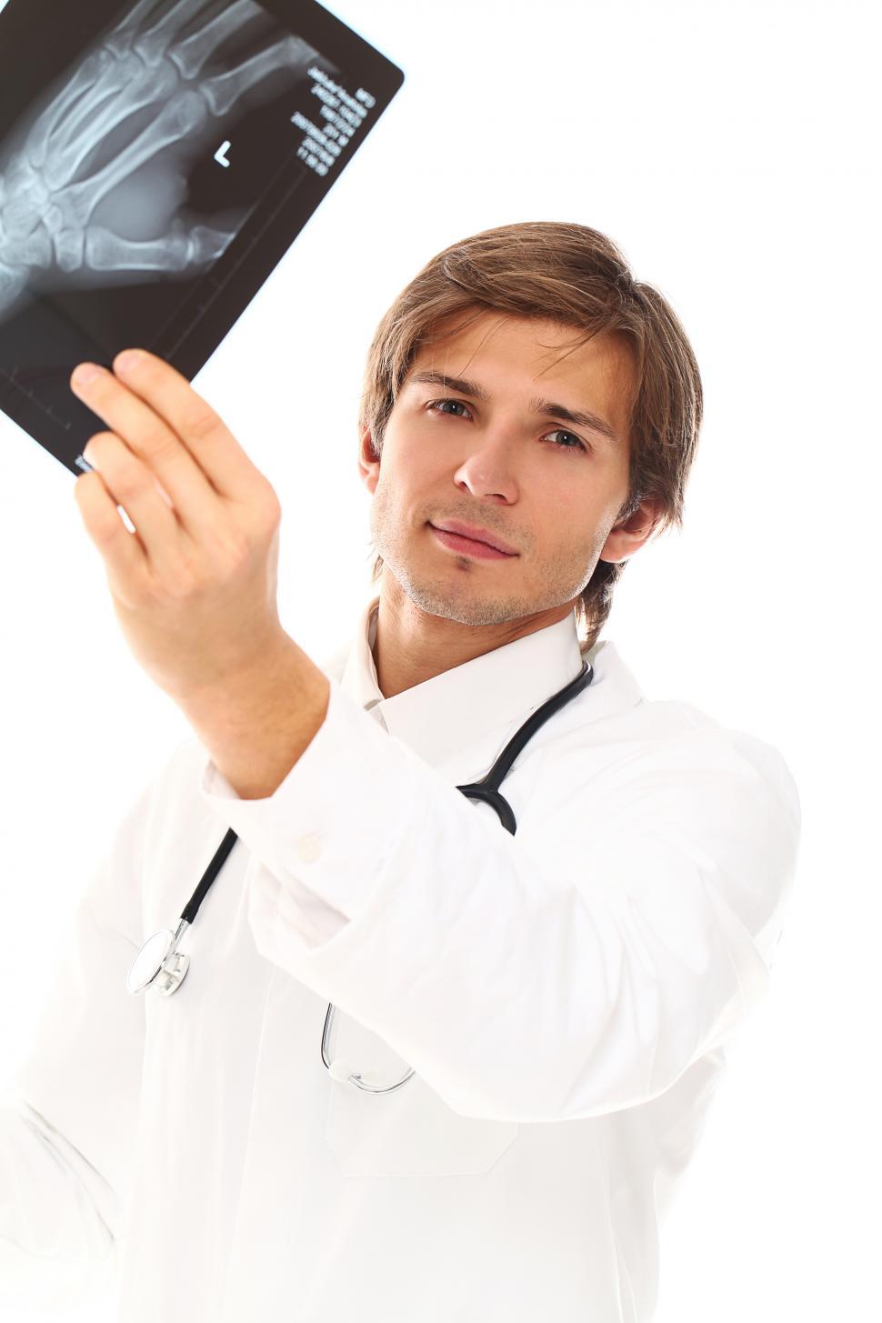 Free Image of Medical provider looking at an x-ray 