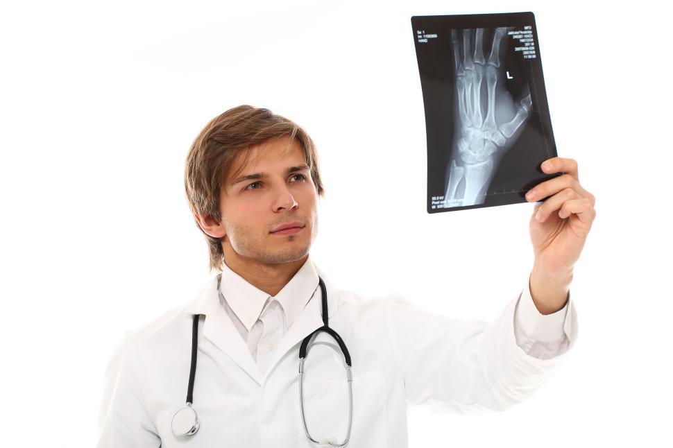 Download Free Stock Photo of Doctor holding up an x-ray transparency  