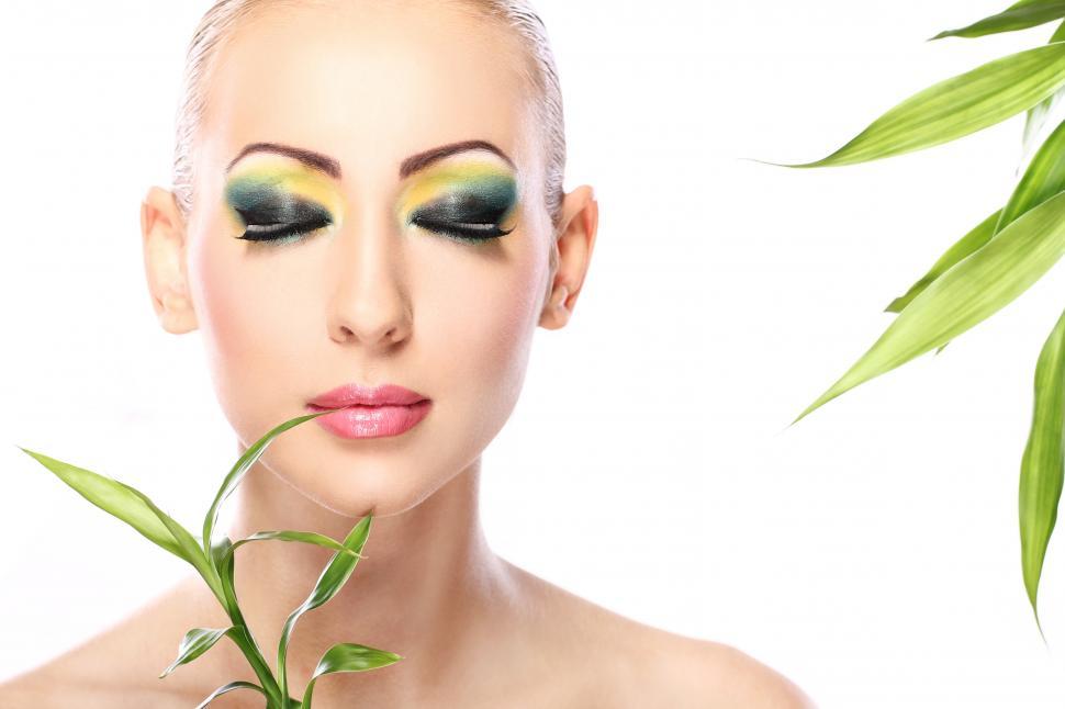 Free Image of Beautiful woman with green and yellow makeup with leaves 