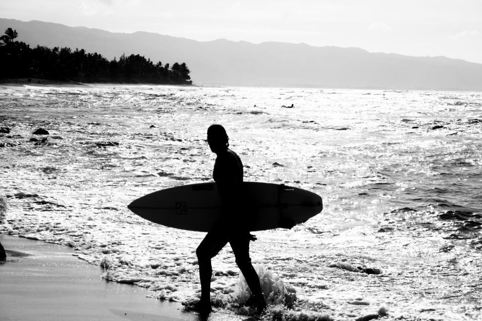 Free Image of Black and white view of surfer on the beach 