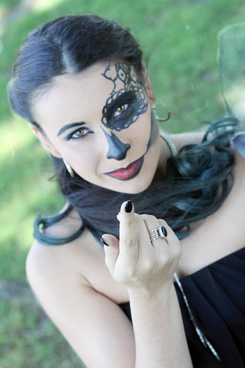 Free Image of Woman with halloween makeup calling with finger in the park 
