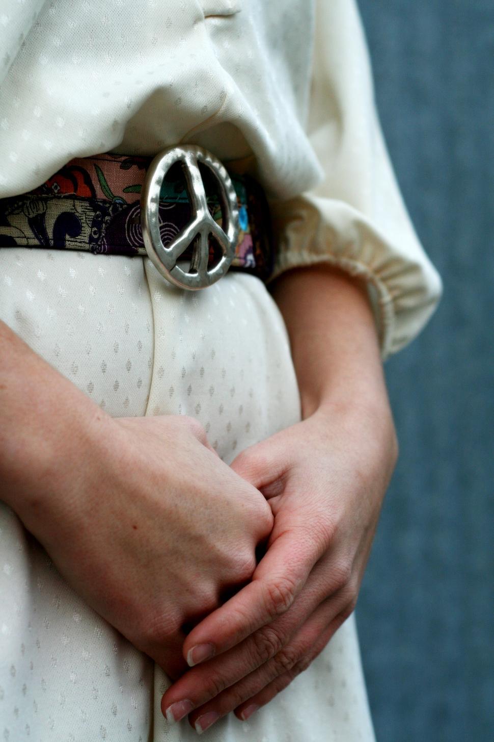 Free Image of Woman hands and peace sign buckle belt 