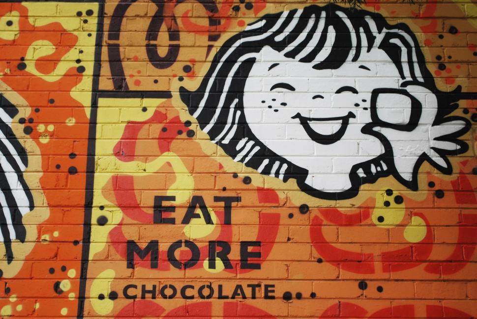 Free Image of Graffiti of smiling child holding a chocolate 