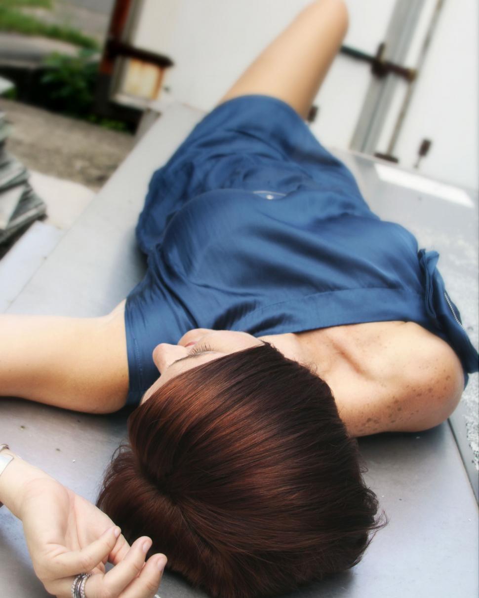 Free Image of Short haired woman sleeping on bench 