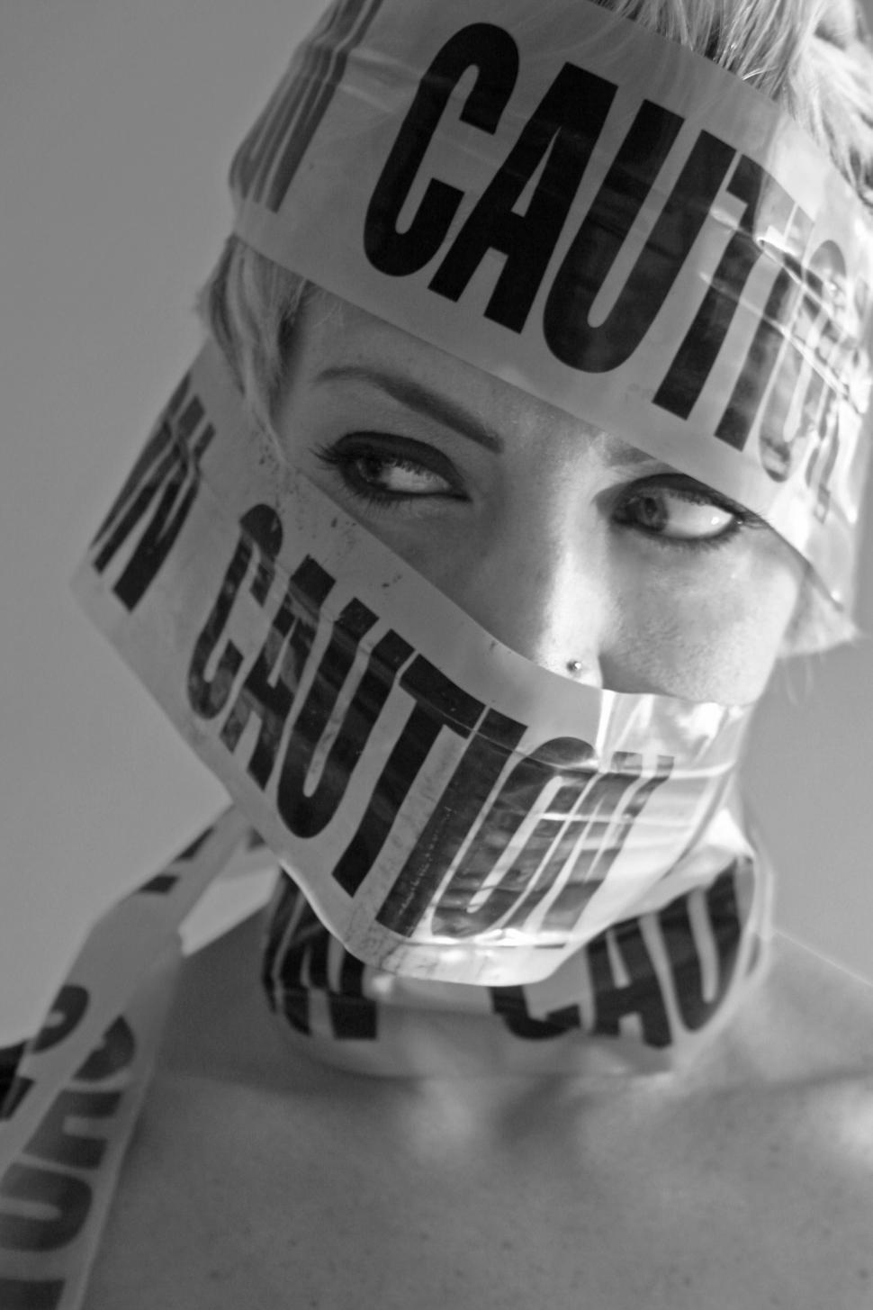 Free Image of Woman face and caution tape - b&w 