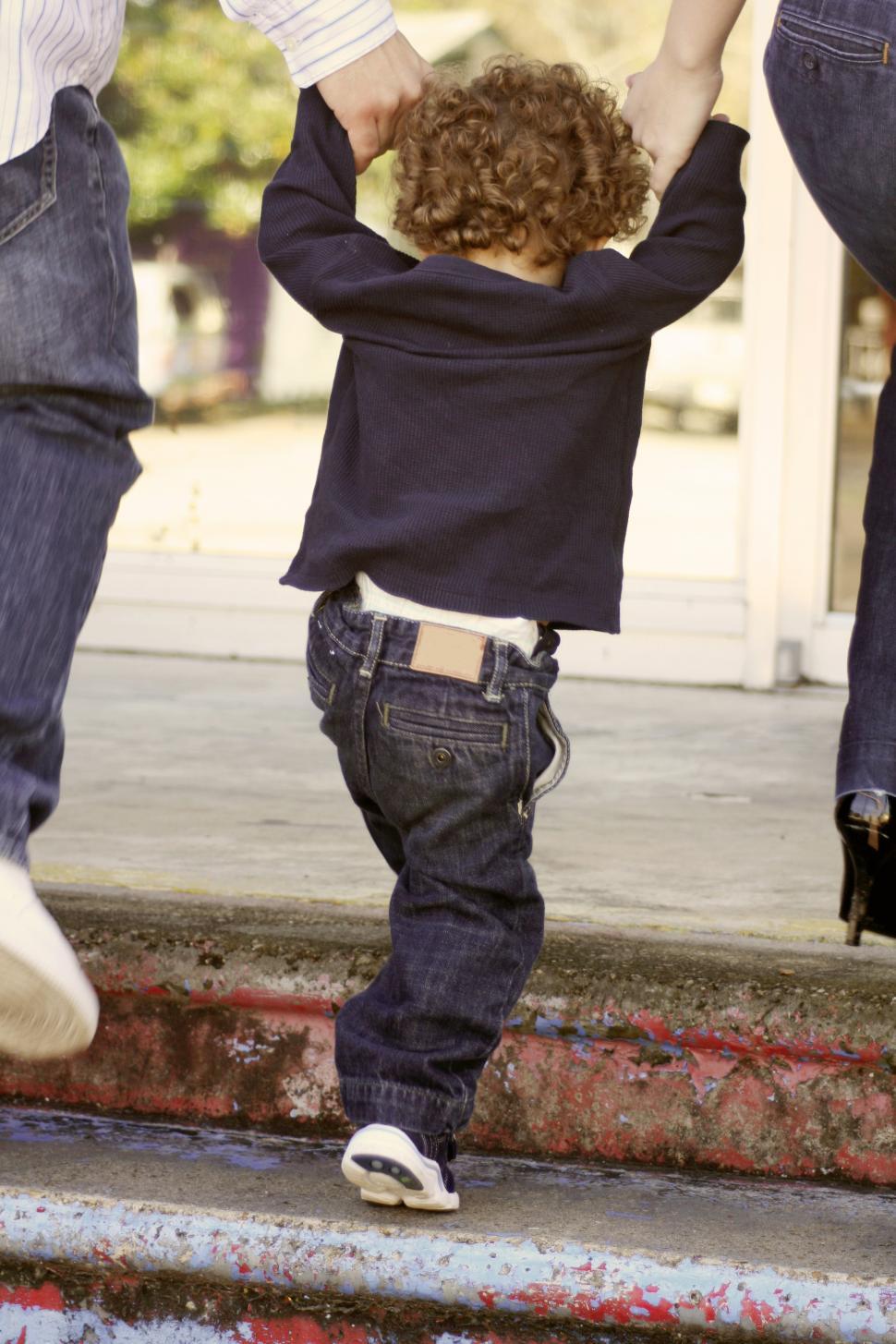 Free Image of Backside view of Boy child walking with parents 