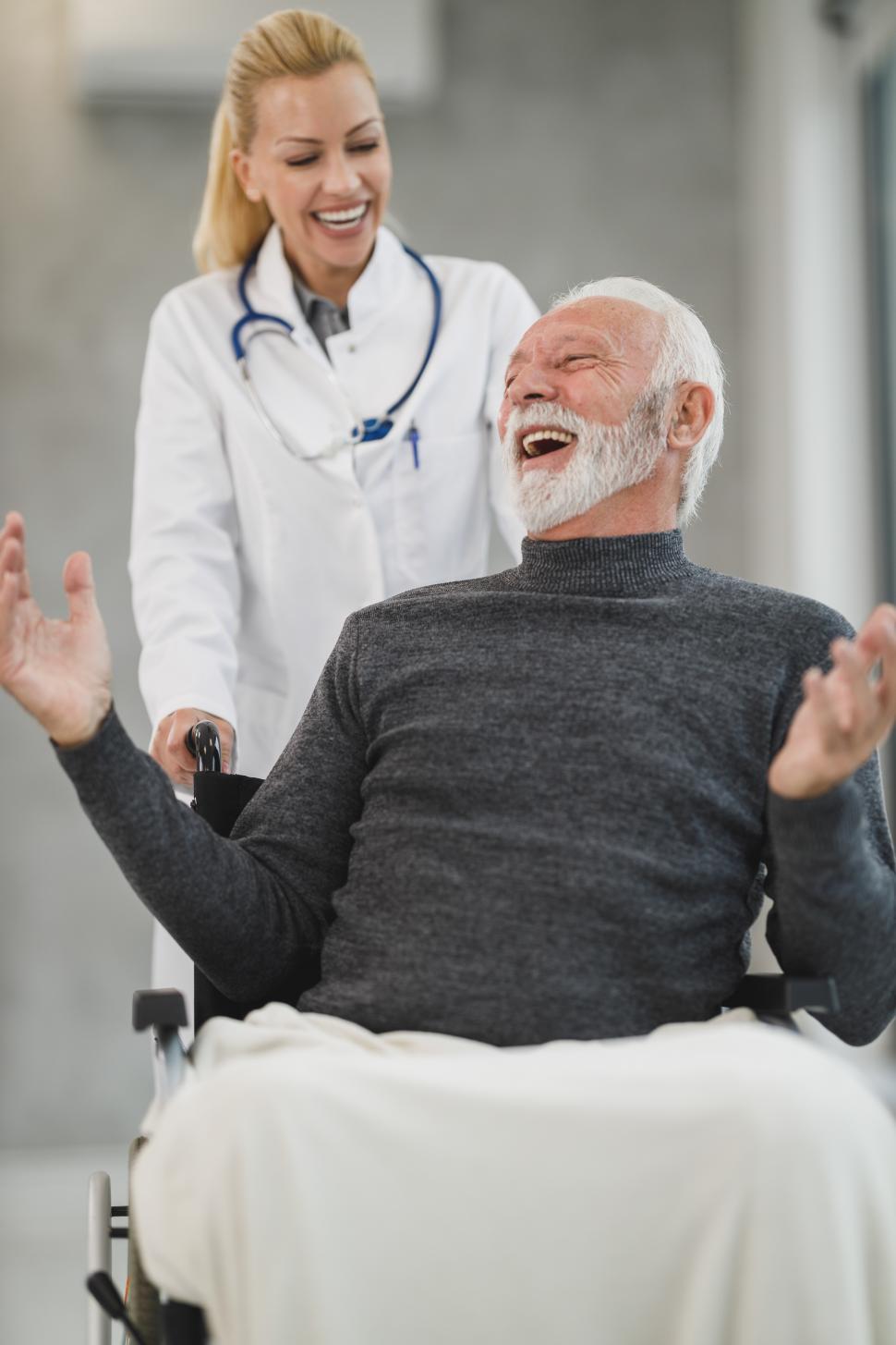 Free Image of Woman doctor with old-aged man in wheelchair 