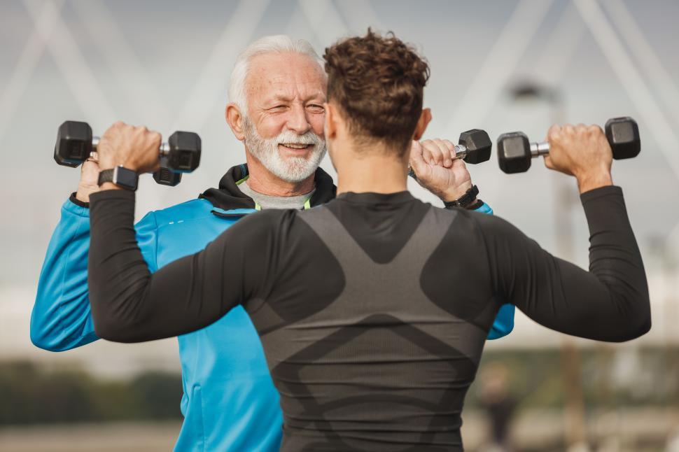 Free Image of Elderly man and young man working out together in a park 
