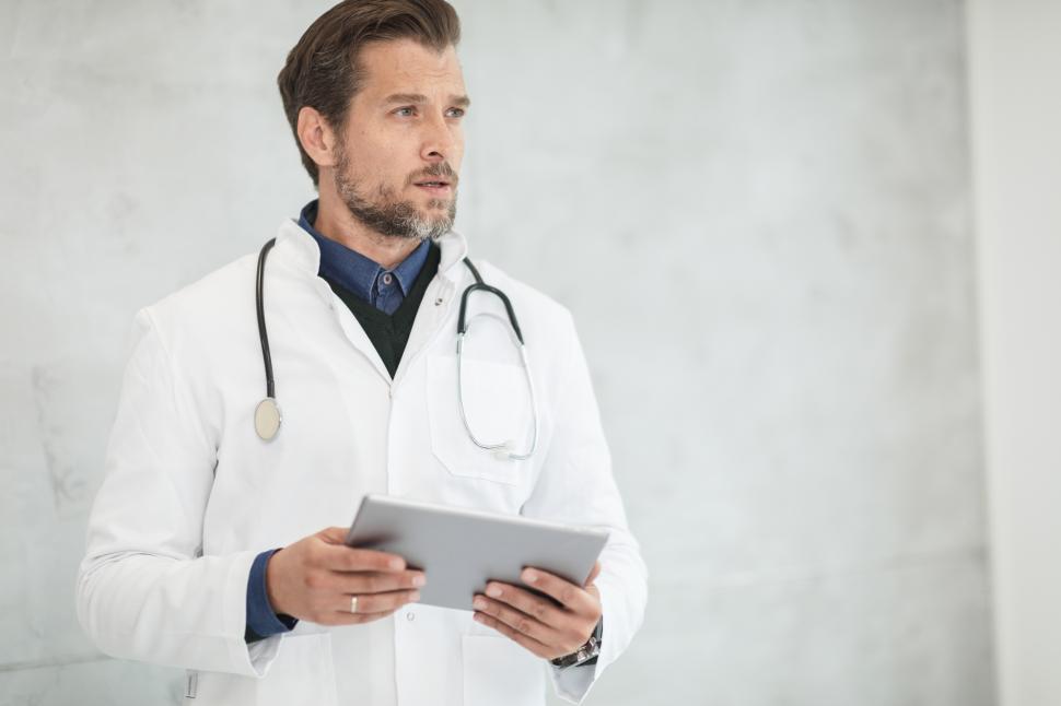 Free Image of Doctor with tablet computer- looking away 