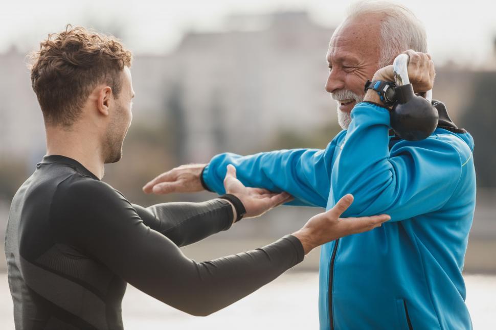 Free Image of Young man exercising with old man 