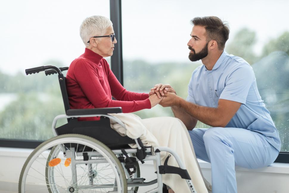 Download Free Stock Photo of Healthcare worker with old-aged woman in wheelchair 