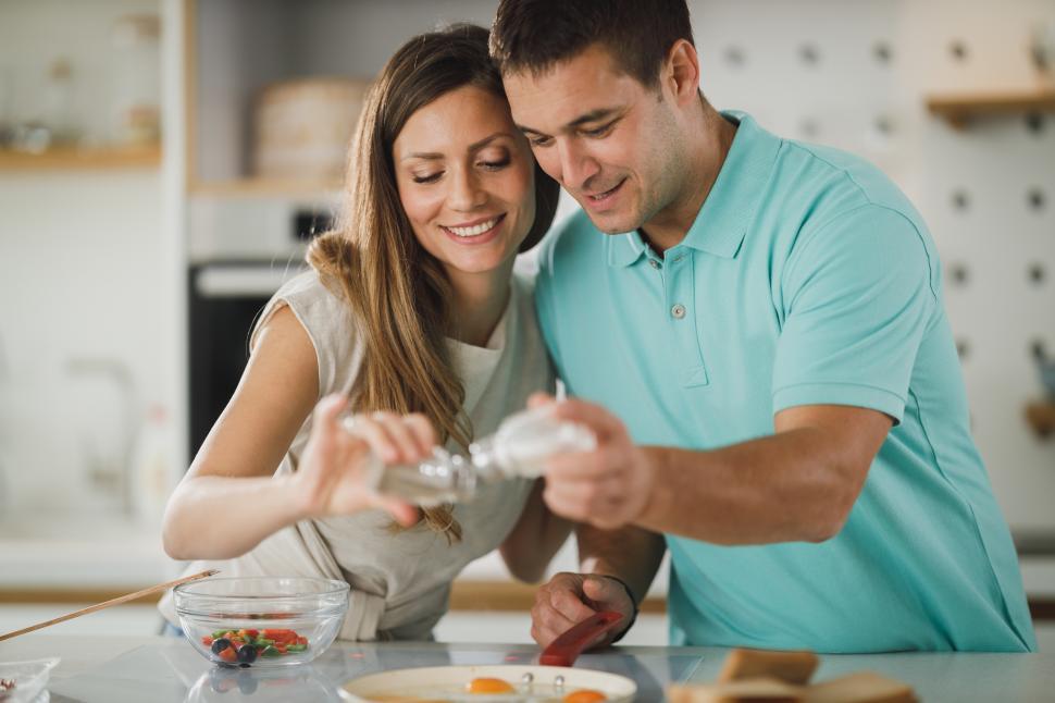 Free Image of Happy couple cooking in the kitchen 