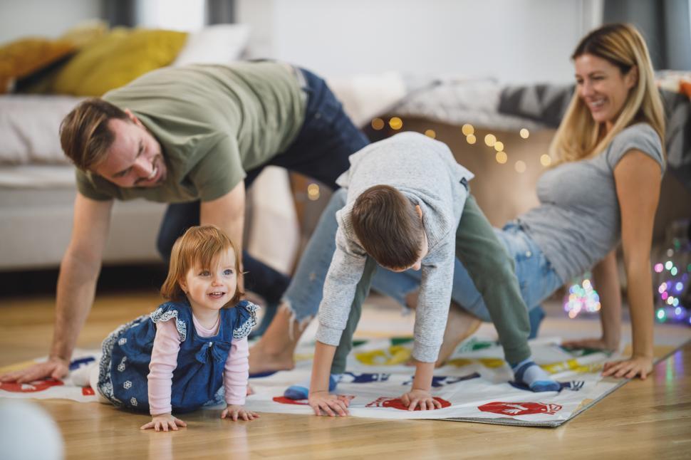 Free Image of Young parents playing with children at home 